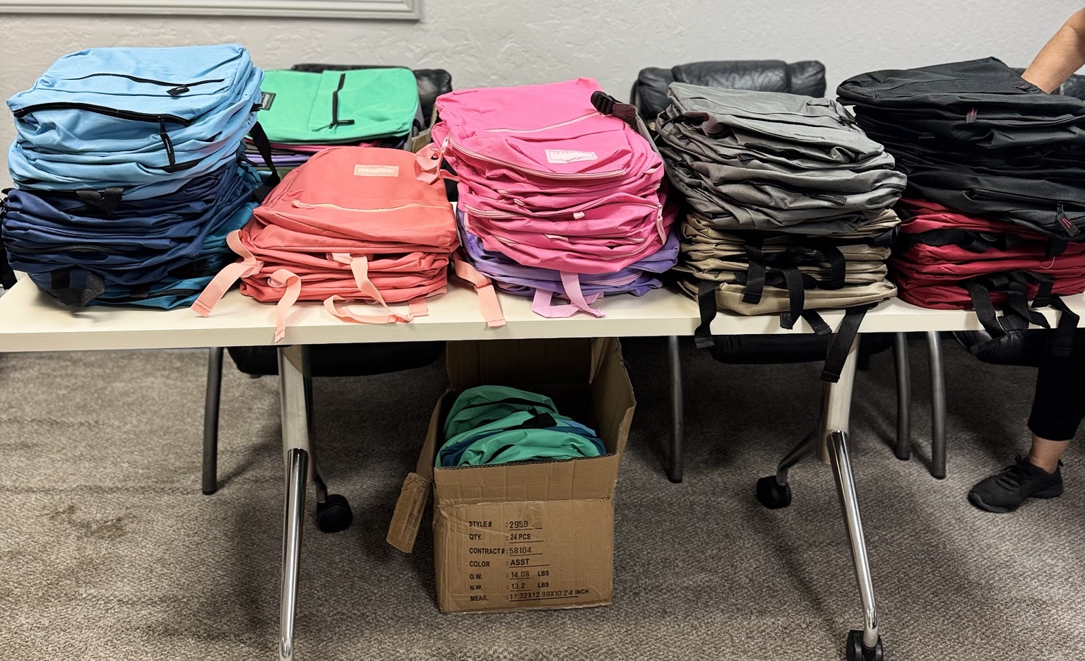 Colorful donated backpacks ready for distribution to local students