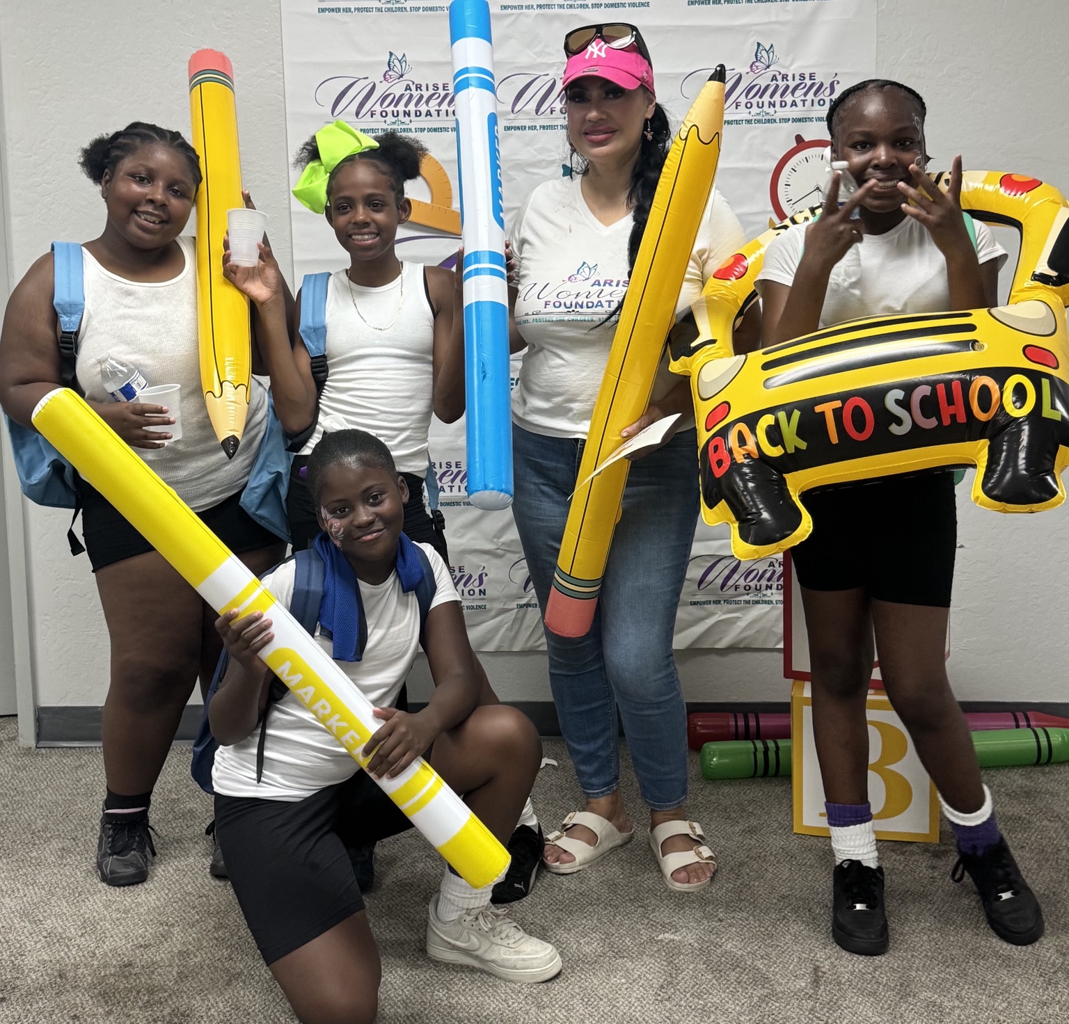 Arise Women’s Foundation celebrating with students at its annual backpack drive